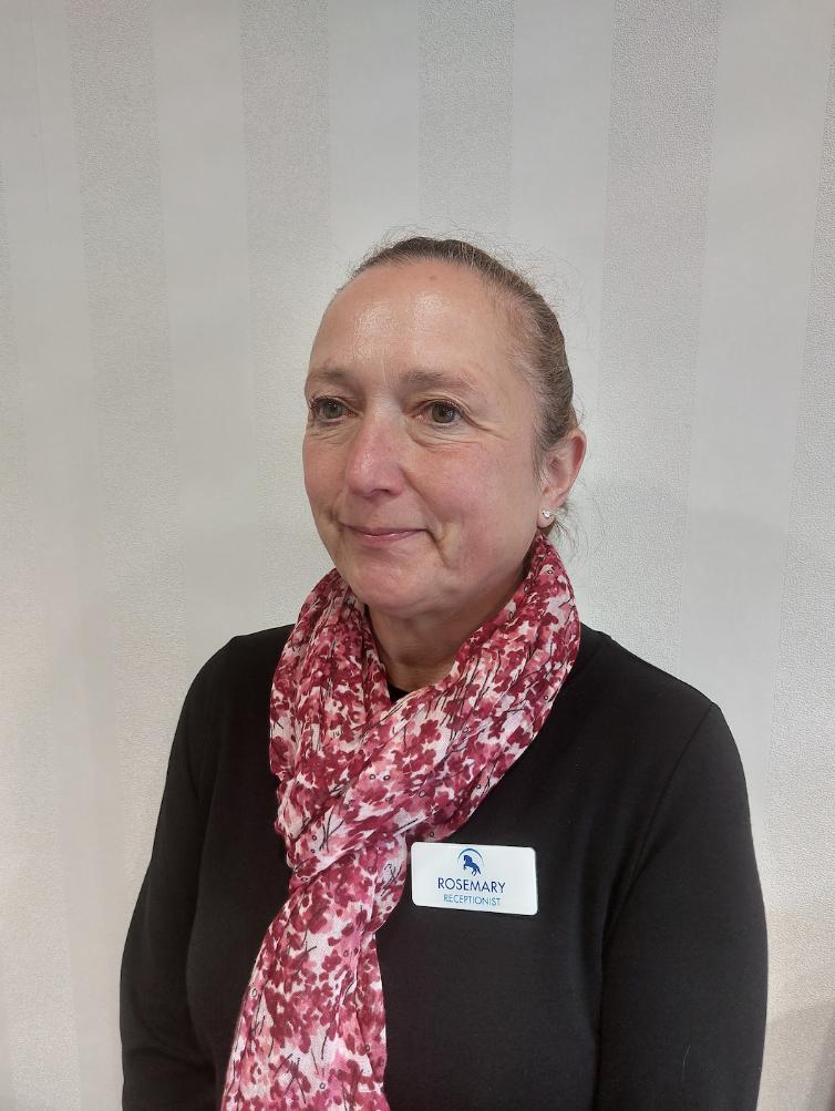 lady with a red scarf posing for staff photo