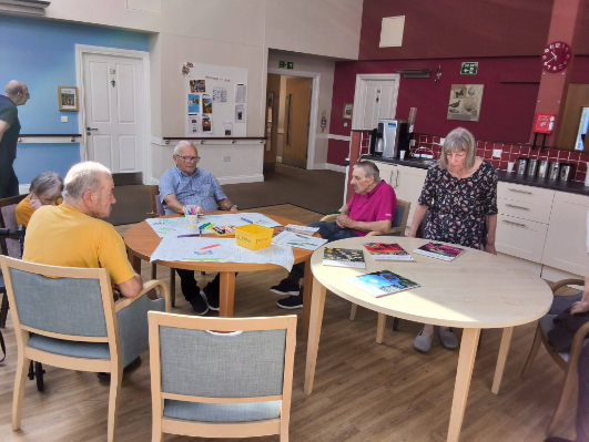 Residents colouring a jungle scene during a creative activity